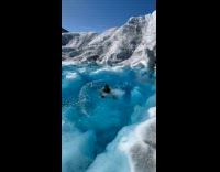Woman jump swim in cold glacier water