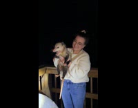 Woman posing with opossum she caught