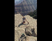 Woman blue jean shorts handstand attempt mountain