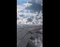 View of clouds inside the airplane window