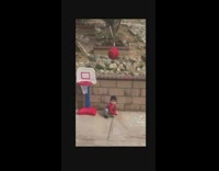 Guy throws red ball against wall baby