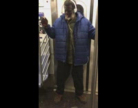 Man on a subway train lighting and smoking a blunt drops it on the floor and picks it back up