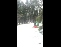 Guy on snow tube falls on back 