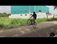 Guy does bicycle wheelie falls on dirt 