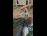 Little baby with mouth open cries to dad 