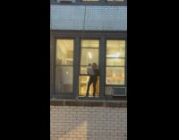 Woman outside window to draw the building