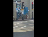 Grey jacket girl poses by wall mural 