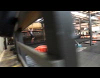 gym training man grey shirt jumps falls off rail