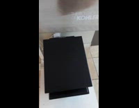 Black toilet lid opens in close proximity