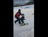 Lady Have Toddler Hold on Ski Lift 
