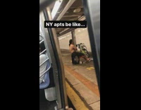 Black shorts guy sits crate subway station