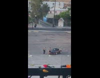 Girl black shirt sit on car  hood