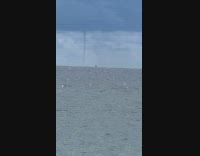 Woman films tornado approaching near the beach
