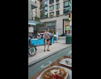 Man walks around street in leotard 