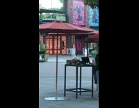 Black skirt girl dances alone outside plaza 