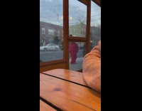 Person wears long red dress and hat 