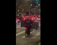 Guy carries furniture while riding bicycle 