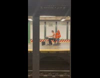 Shirtless guy plays piano at subway station by platform 