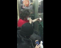 long haired man licks pint of ice cream