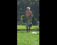 Grandpa lifts chair and shoes park grass