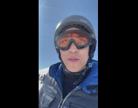 Guy skiing runs into another unaware skier