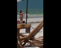Man pink shorts fan dance at beach
