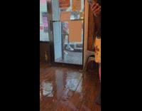 Guy outside in rain touches deep puddle 