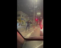 Woman pose on road center island night