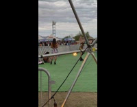 Woman in black shiny dress flexes butt for photoshoot