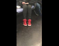 Lady paints nails while riding subway