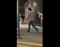 Three men rap music video shoot on the sidewalk