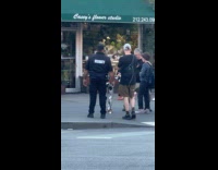 Robot shakes hand with group of people