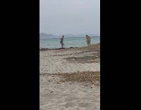 Woman in dress yoga pose at the beach
