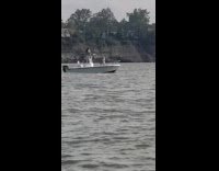 Girl sit over boat roof lake overcast