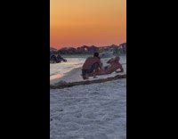 Guy lays on sand for beach photos 