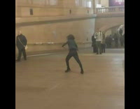 woman in black outfit dancing in train station