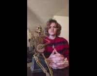 Girl starts banjo playing skeleton toy 