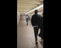 Guy on skateboard uses black stick tunnel