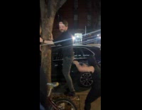 Guy punching man butt standing on tree