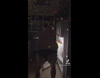 Shirtless guy dances in front of refrigerator door