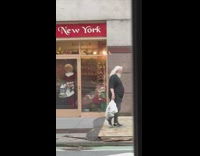 Santa Claus lookalike walks in front of Christmas store