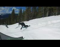 Collab JerrySlams - Snowboarder rides down mountain fast, does a spin off ramp and falls down