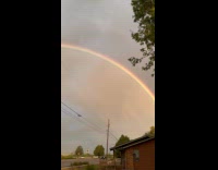 Man reacts at double rainbow in sky