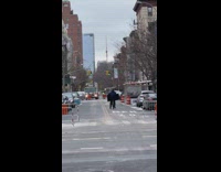 Guy riding bicycle while balancing a widescreen tv