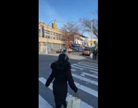 Shirtless man carries green and target bags