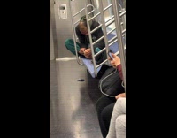 Man cleans his feet inside subway train