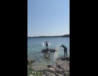 Woman stand beach rock wave white cloth