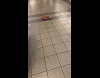 Orange toy car drive around station 