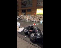 Sidewalk swamped with piles of trash bag