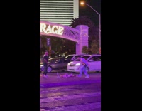 Guy dance pick up camera road center island night